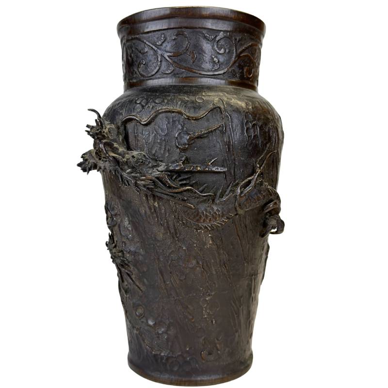 The characteristic deep chocolate-brown patina on antique Japanese bronze.