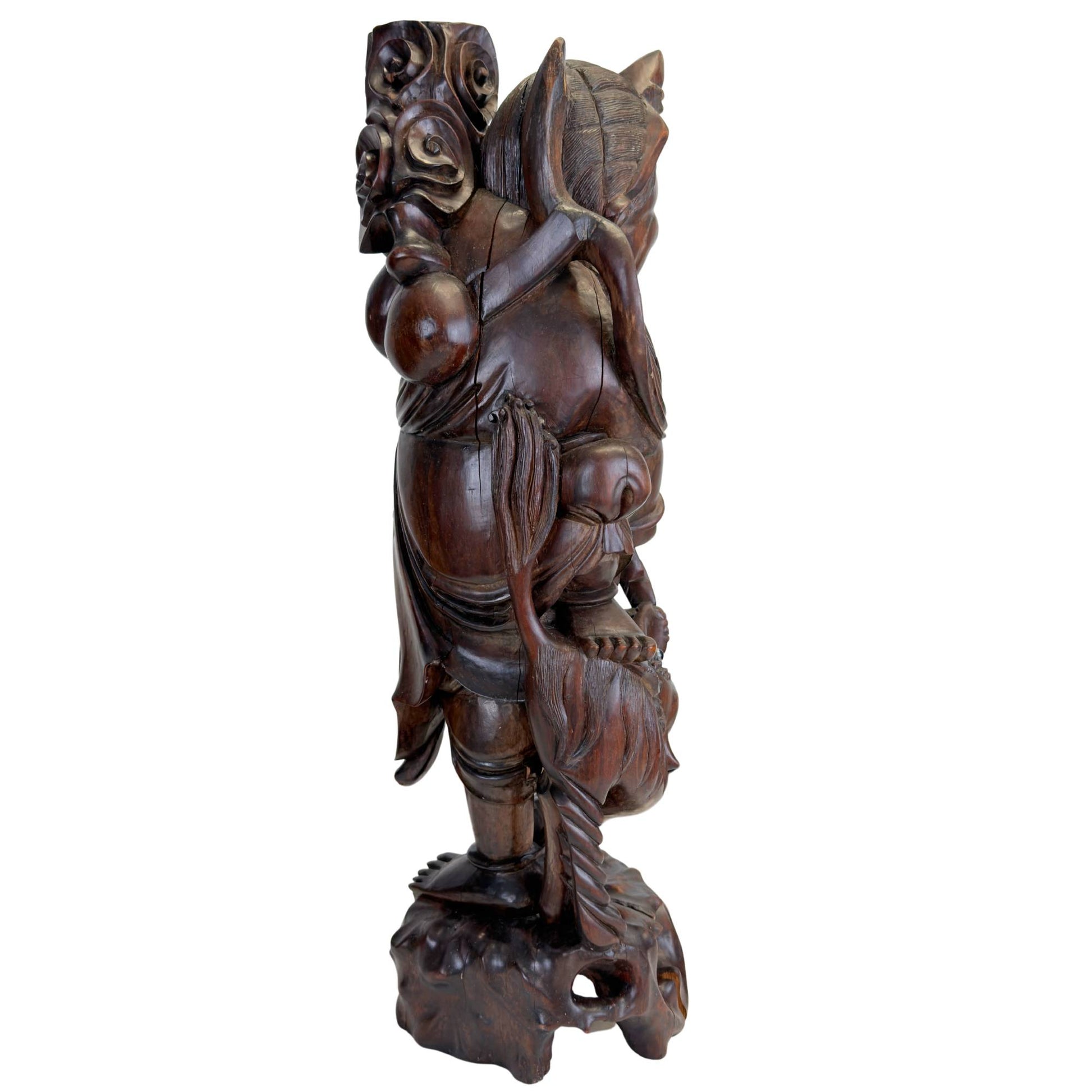 Rear view of the hand-carved Ebisu statue with traditional texture