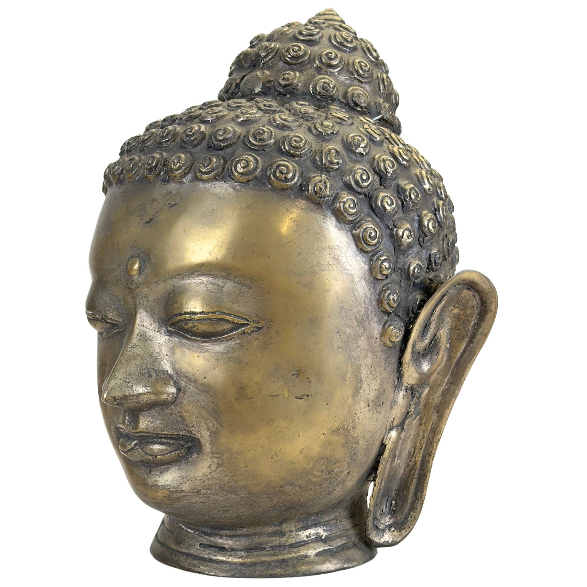 Detail of the serene face of a bronze Buddha head