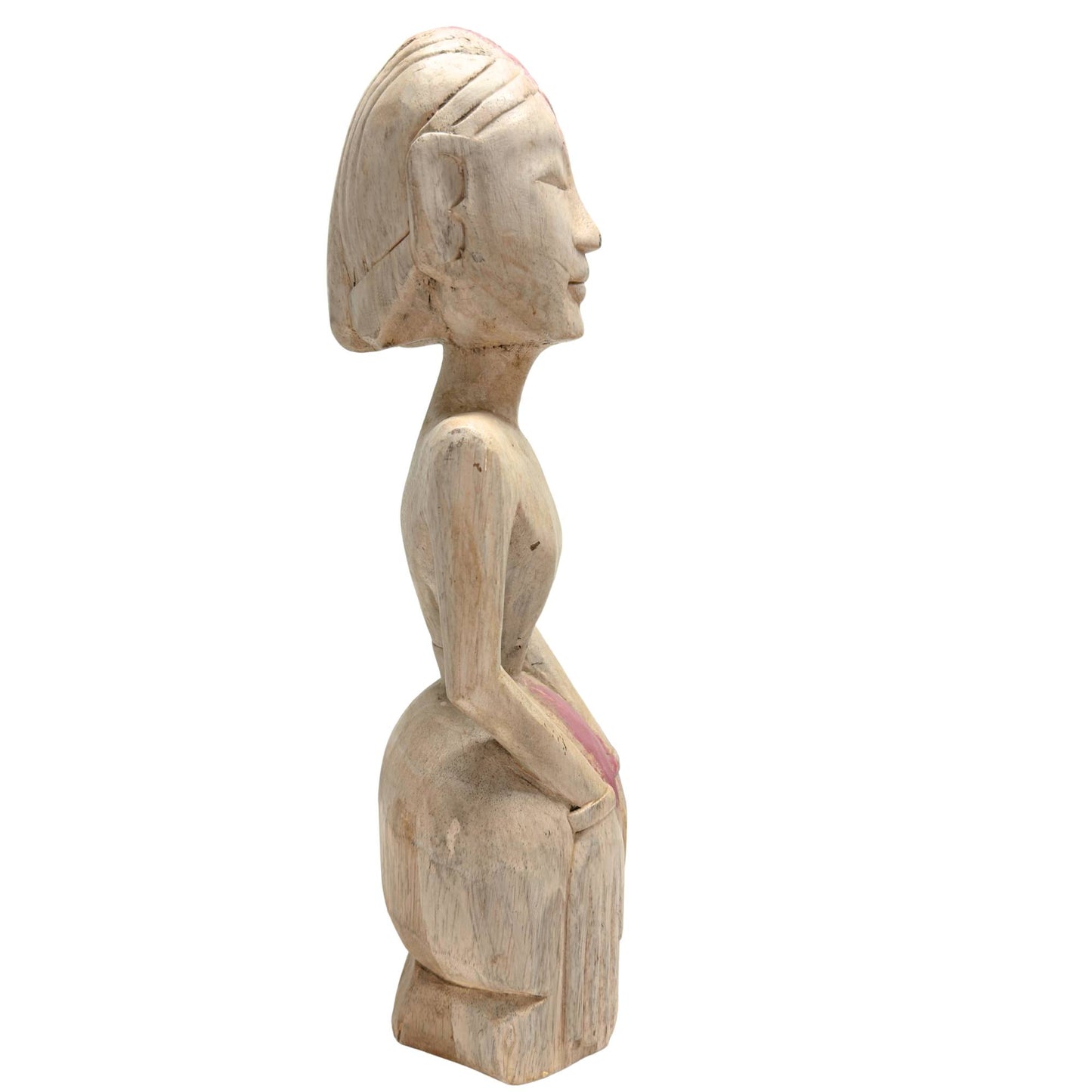 Side view of archaic tribal statue with knot and pink pigment