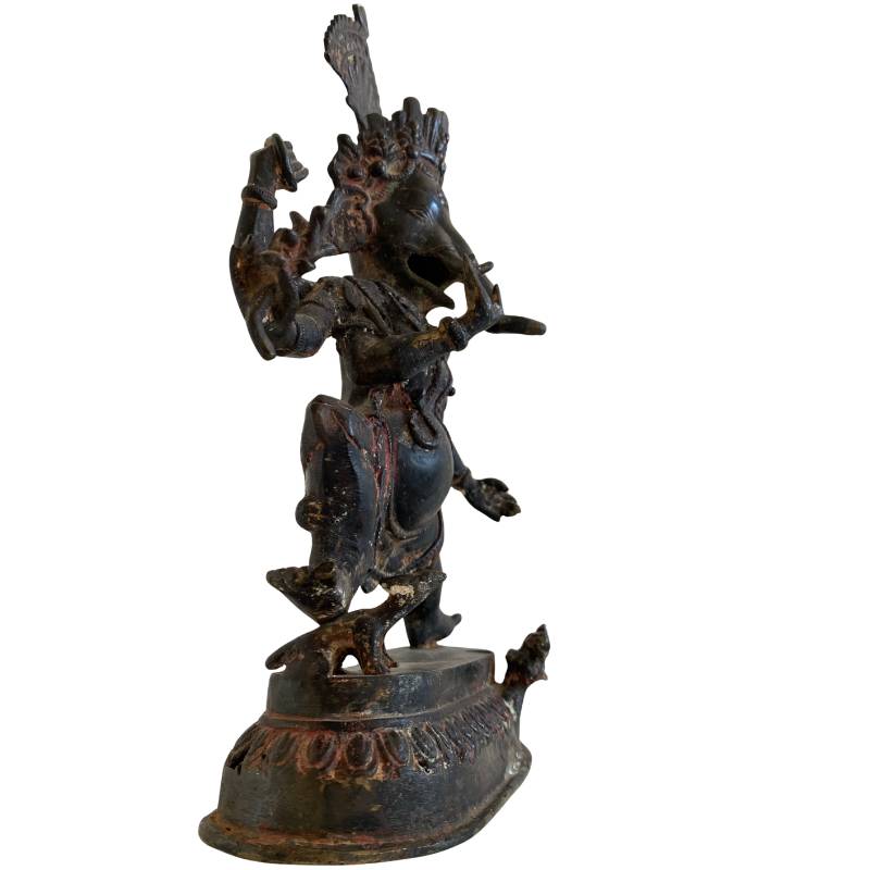 Antique bronze Ganesha statue from Southeast Asia used in a temple context