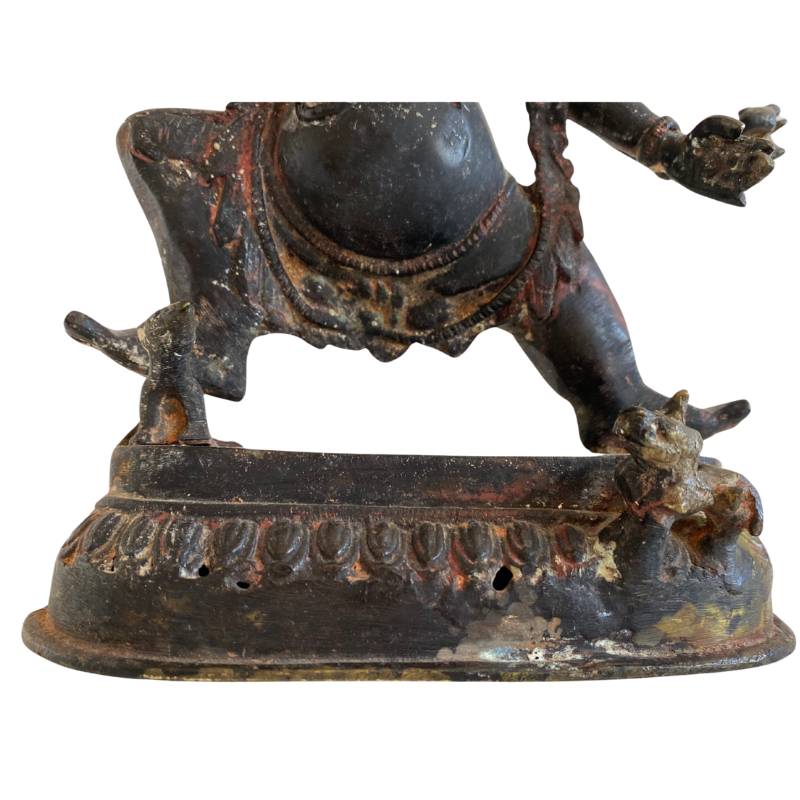 Detail of the elephant head and crown of an antique Ganesha statue in bronze