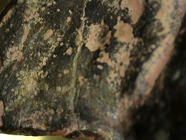 Microscopic patina buildup with cuprite and oxidation on Ganesha statue
