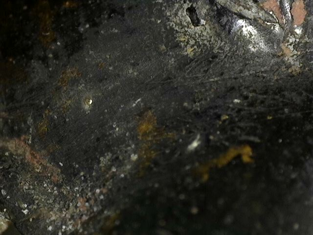 Microscope detail of ritual contact wear on an antique bronze Ganesha
