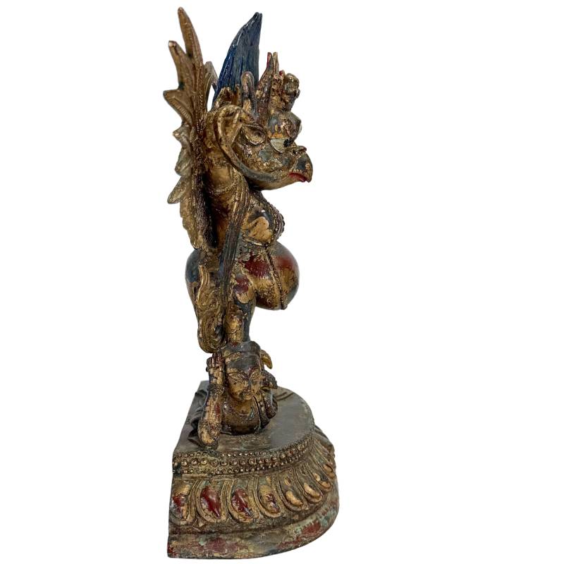 Garuda statue standing on a demon in bronze from the Himalayan tradition