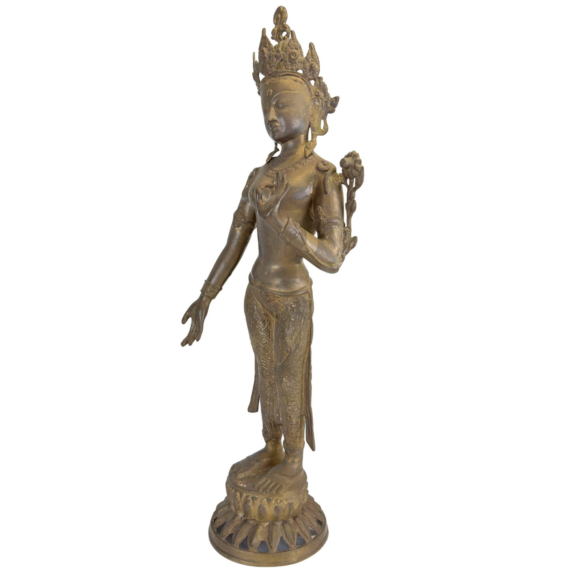 Detail of the bust of an antique Green Tara with lotus, crown, and original fire gilding.