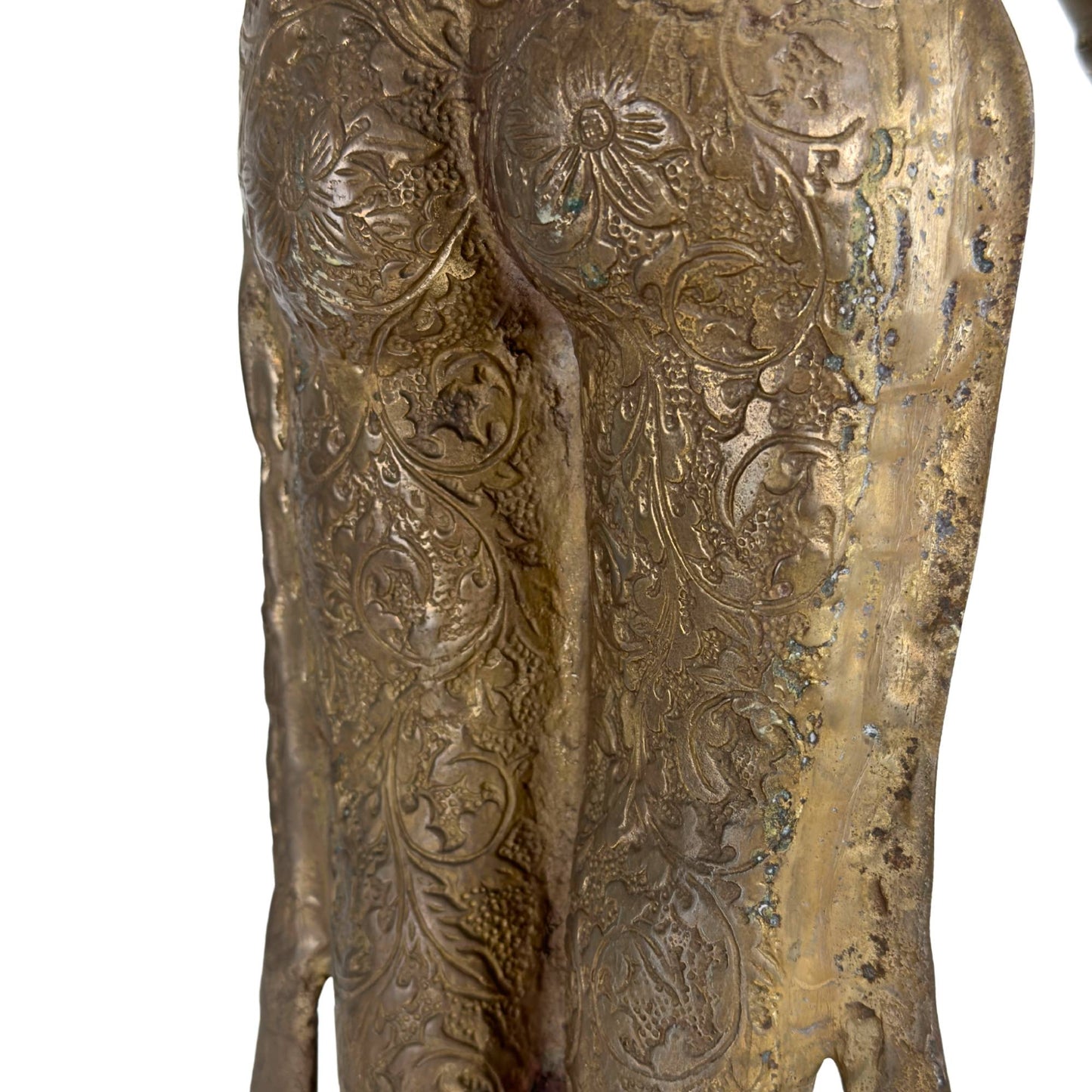 Close-up of the richly engraved dhoti with floral motifs, natural patina, and remnants of fire gilding.
