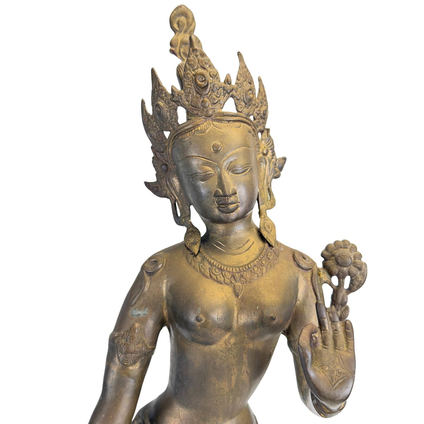 Close-up of the face, the crown, and the original fire gilding of an antique Nepalese Green Tara.