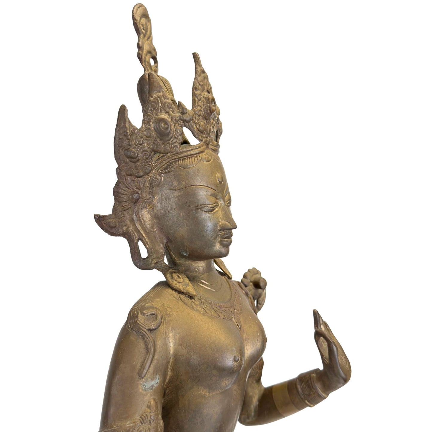 Detail of the left profile of the antique Green Tara with crown, jewelry, and original fire gilding.