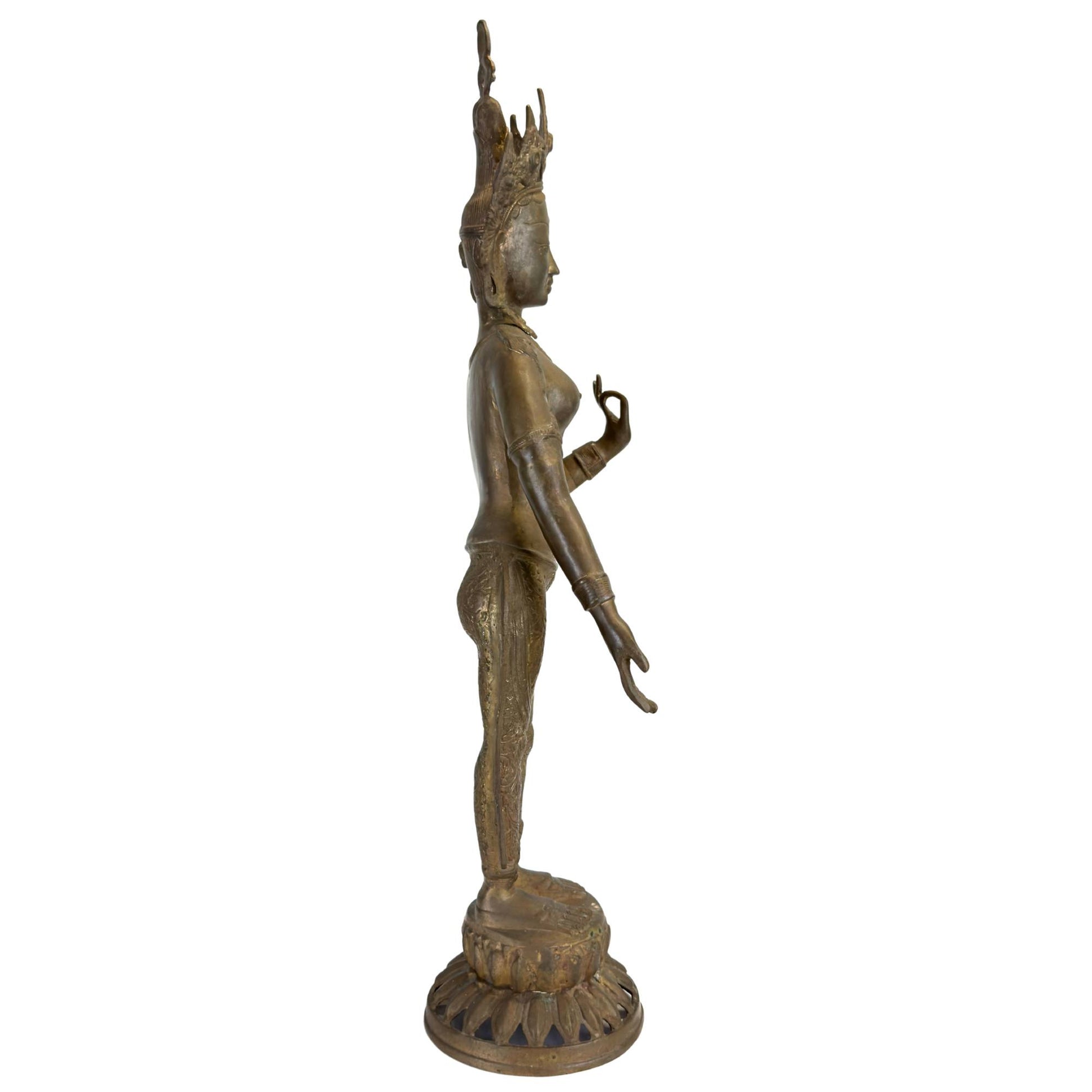 Left profile of an antique bronze Green Tara from Nepal on a lotus base.