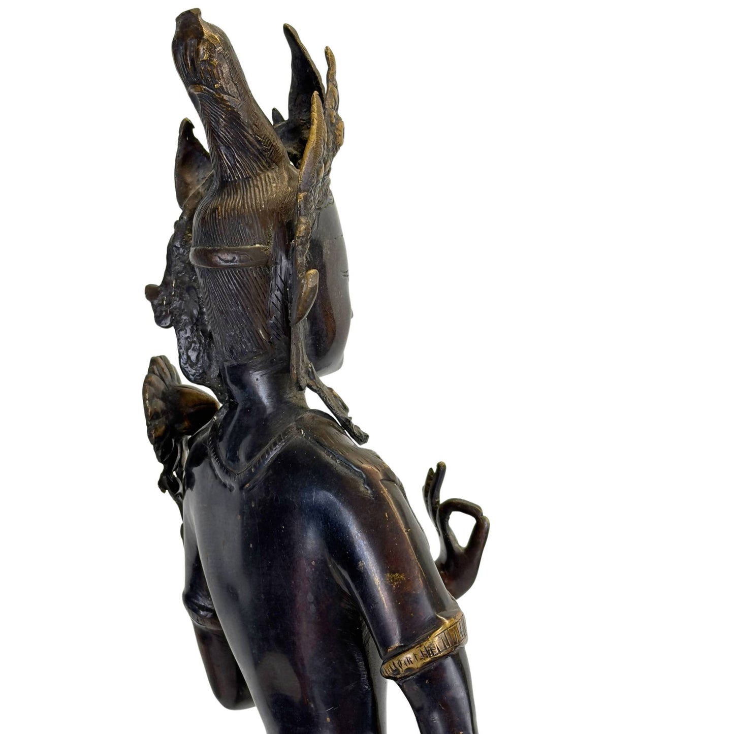 Back of an antique bronze Green Tara from Nepal with engraved hair, black Newar patina, and fire-gilded details.