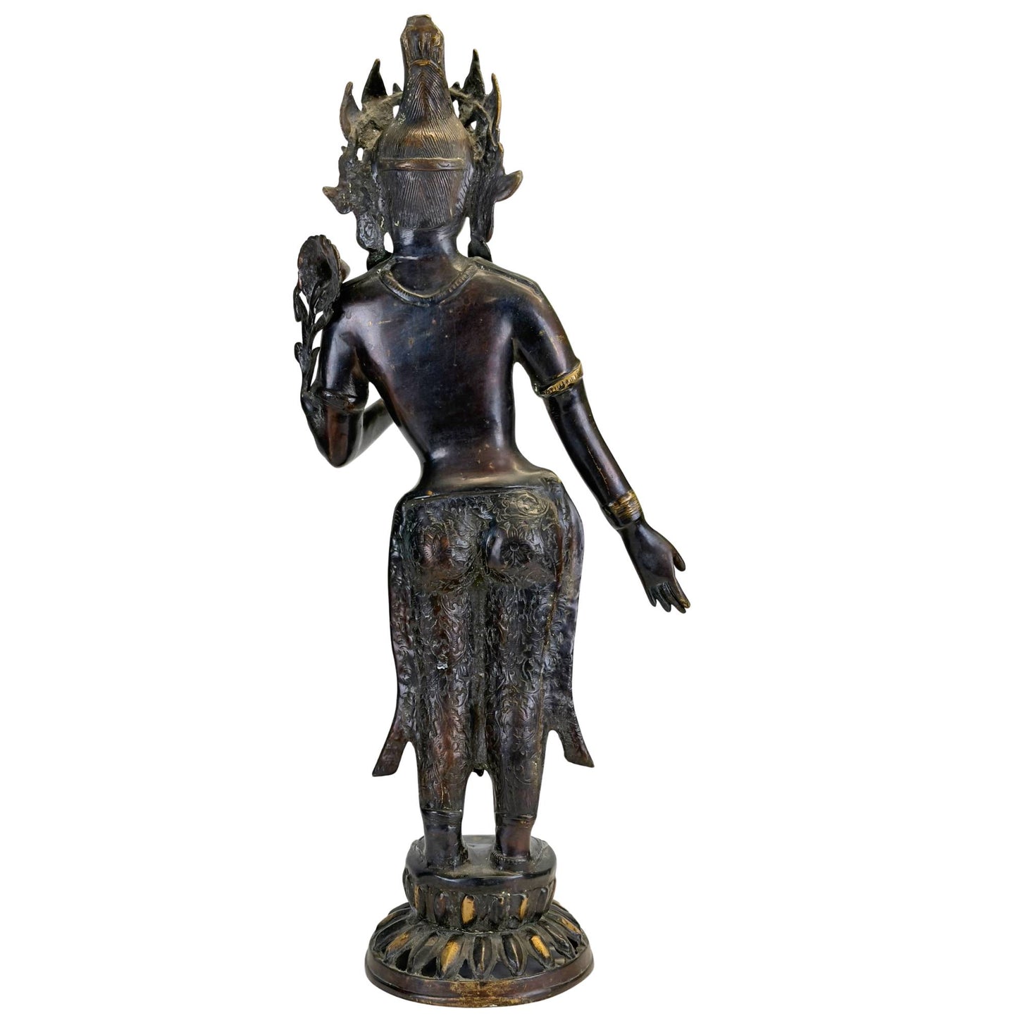 Left profile of an antique bronze Green Tara from Nepal with lotus stem, tribhanga posture, and black ritual patina.