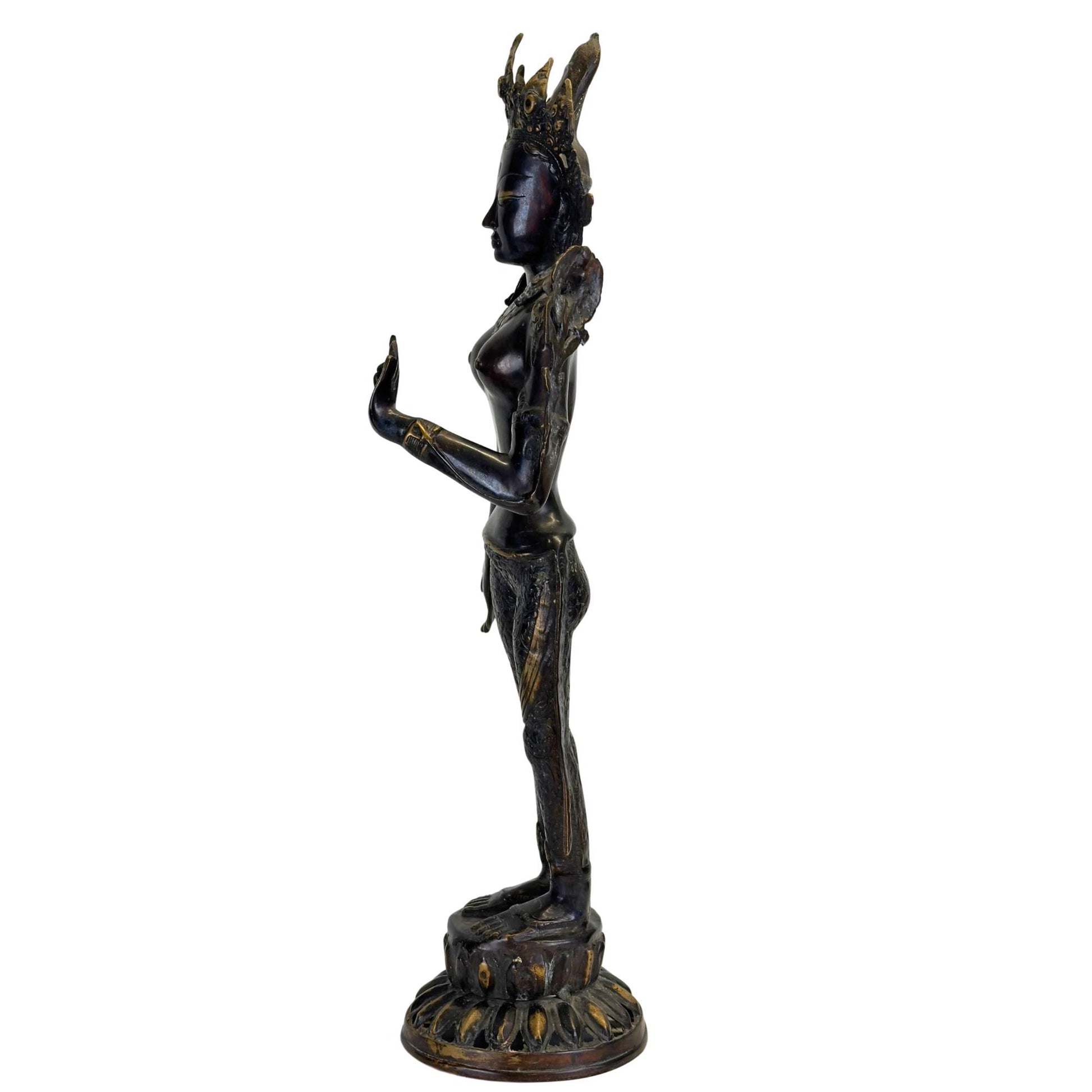 Side view of an antique bronze Green Tara from Nepal with an elegant tribhanga pose, black Newar patina, and fire-gilded details.