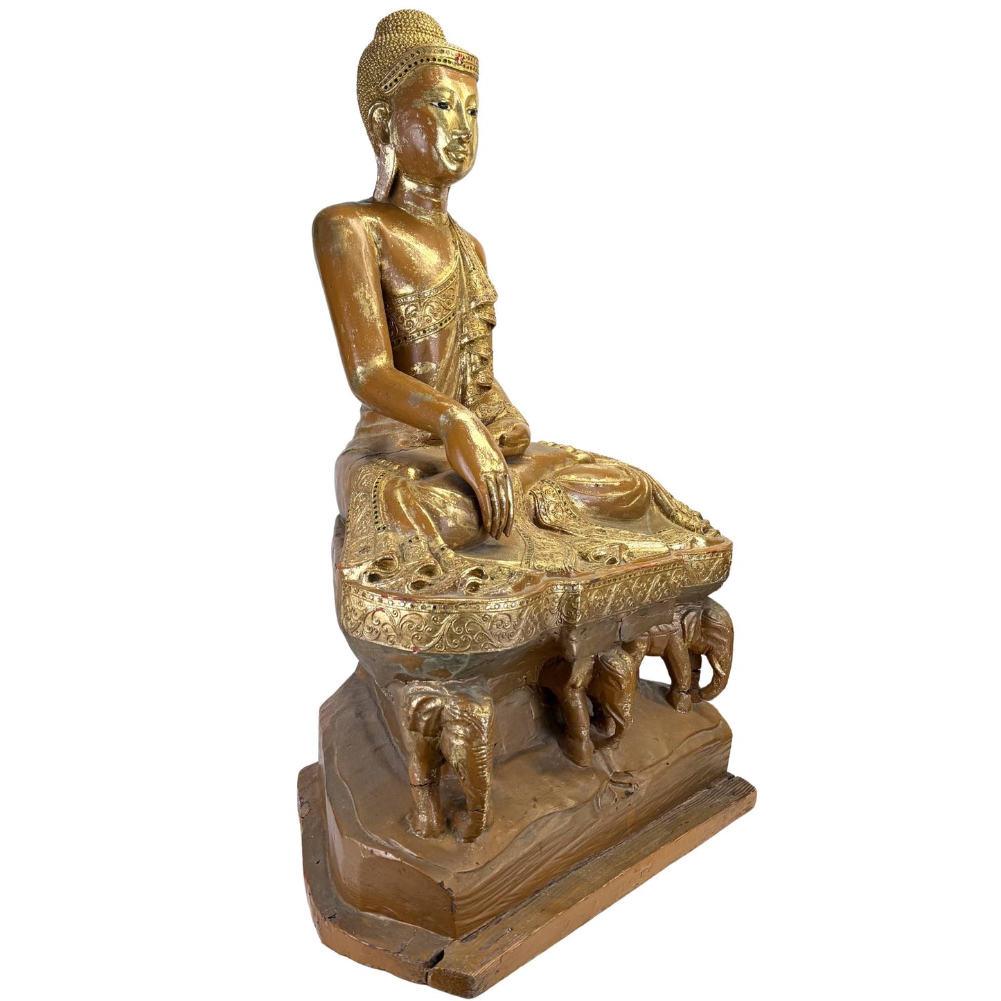 Large antique Burmese Buddha on a raised throne with elephants, lacquer gold, and richly decorated robes