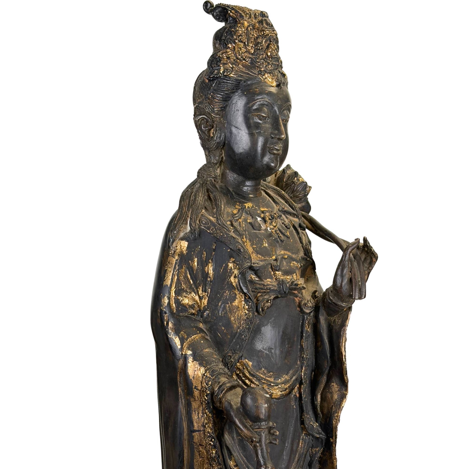 Guanyin bodhisattva statue with black lacquer, wear and remnants of gilding