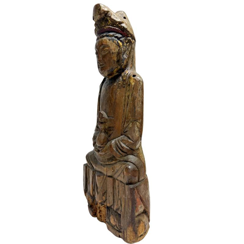 Antique wooden Guanyin sculpture with ritual background and character