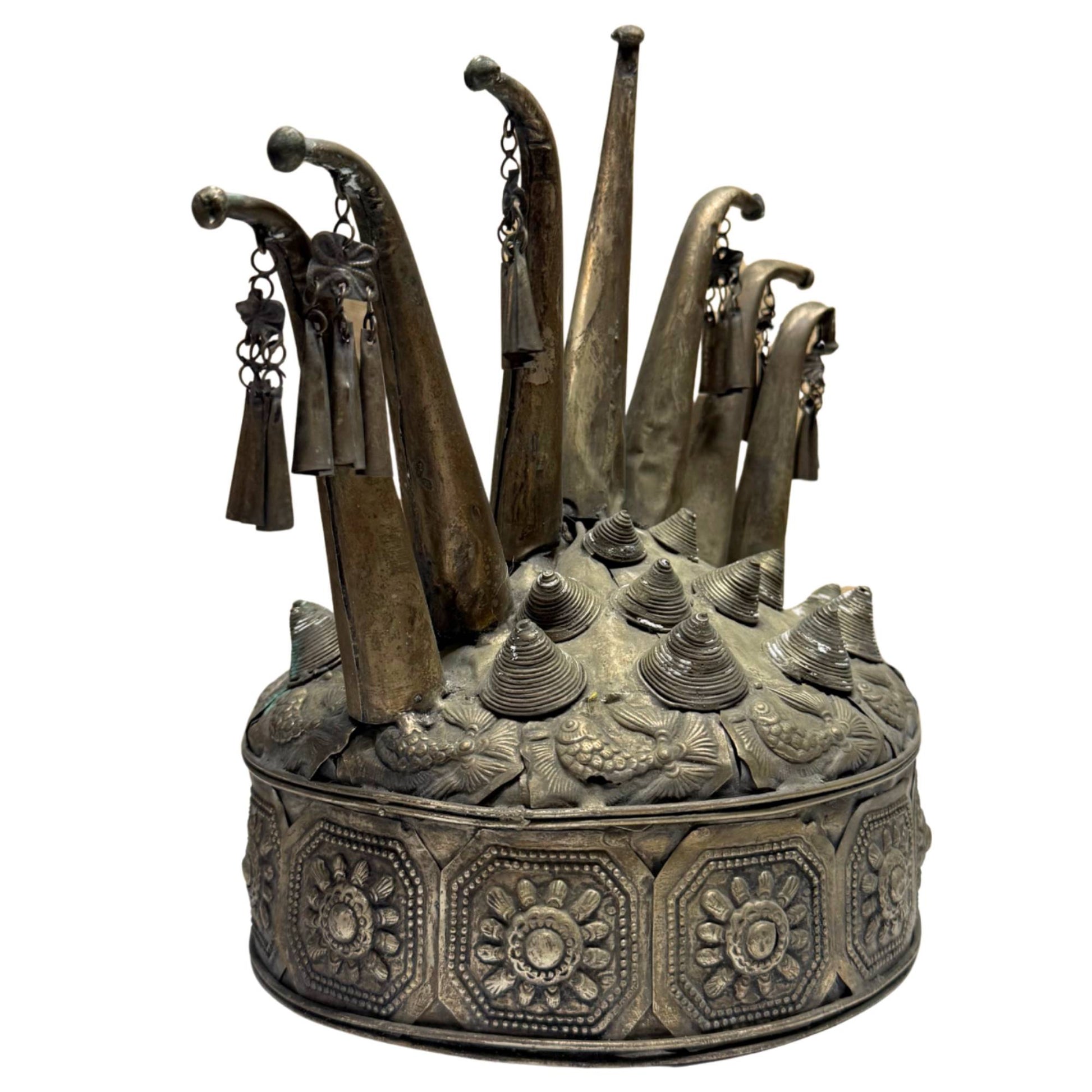 Hand-beaten metal Miao crown from Southeast Asia, richly decorated with hanging bells and old patina