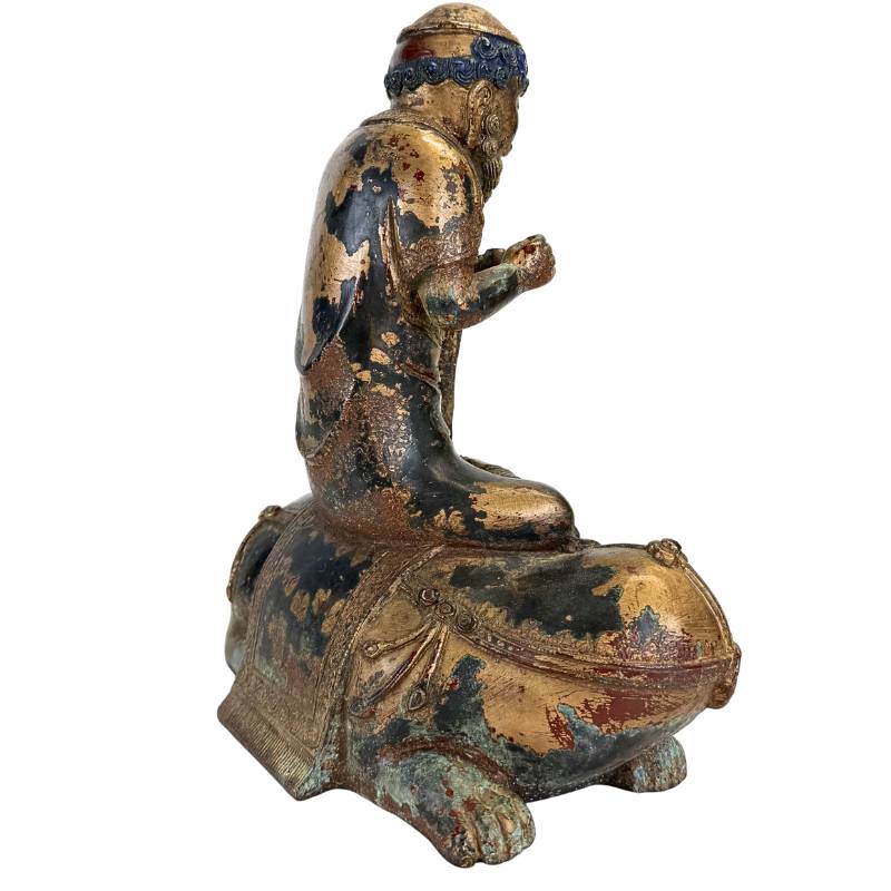 Himalayan Arhat statue sitting on an animal in bronze