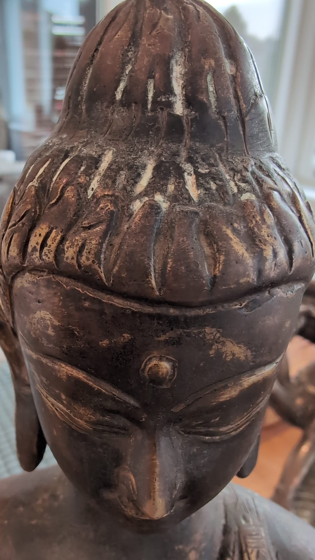 Detail of Himalayan bronze Buddha with oxidation and layered patina