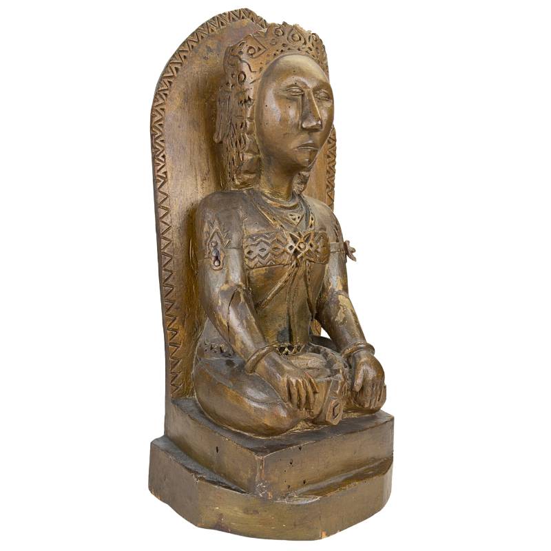 Hand-carved wooden Sri Devi statue with visible traces of gold.