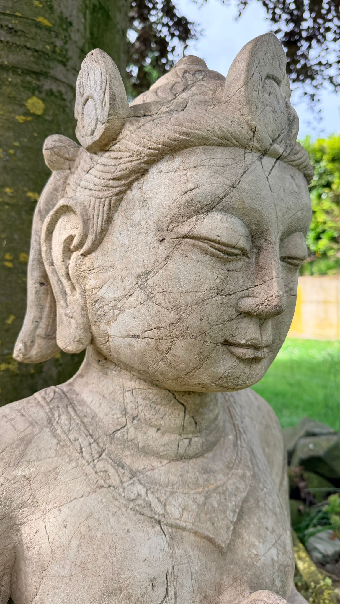 Indonesian temple figure with traditional crown and ornate details