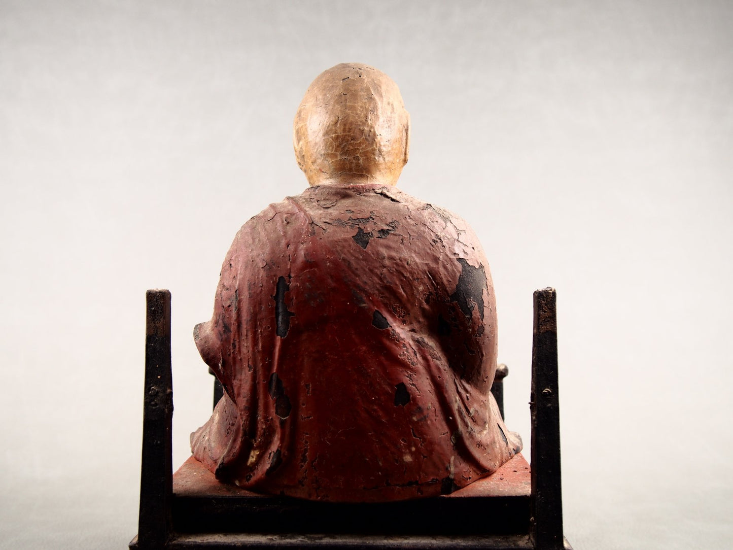 Japanese home altar with wooden monk statue
