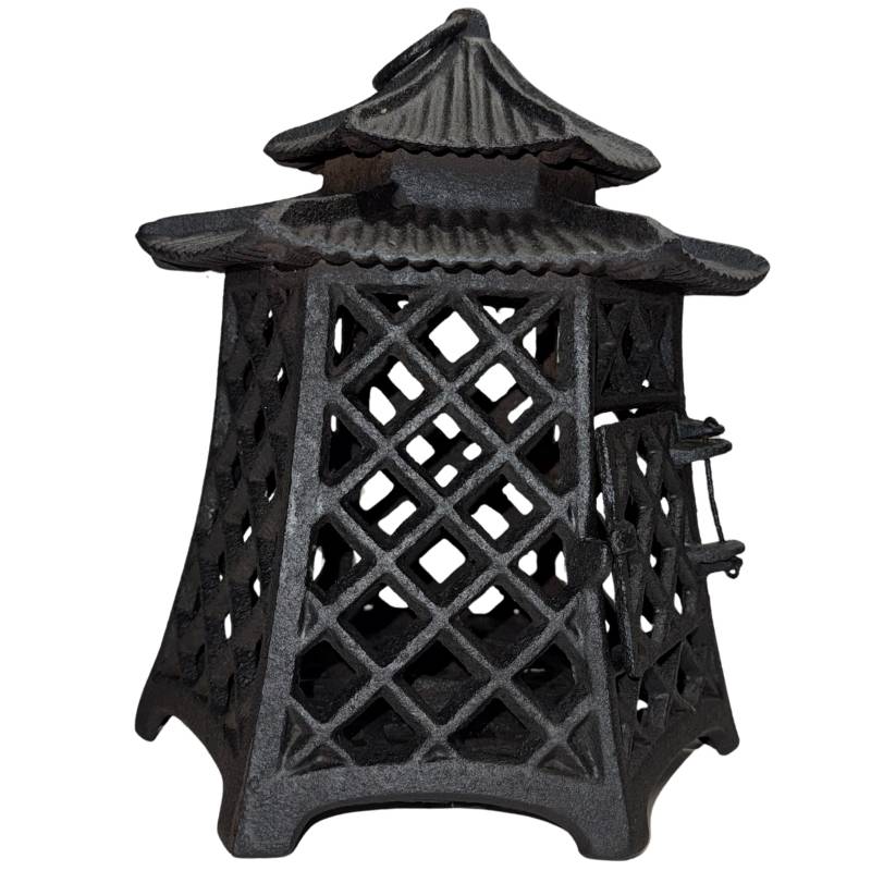Atmospheric Japanese pagoda lantern with burning candlelight for the garden