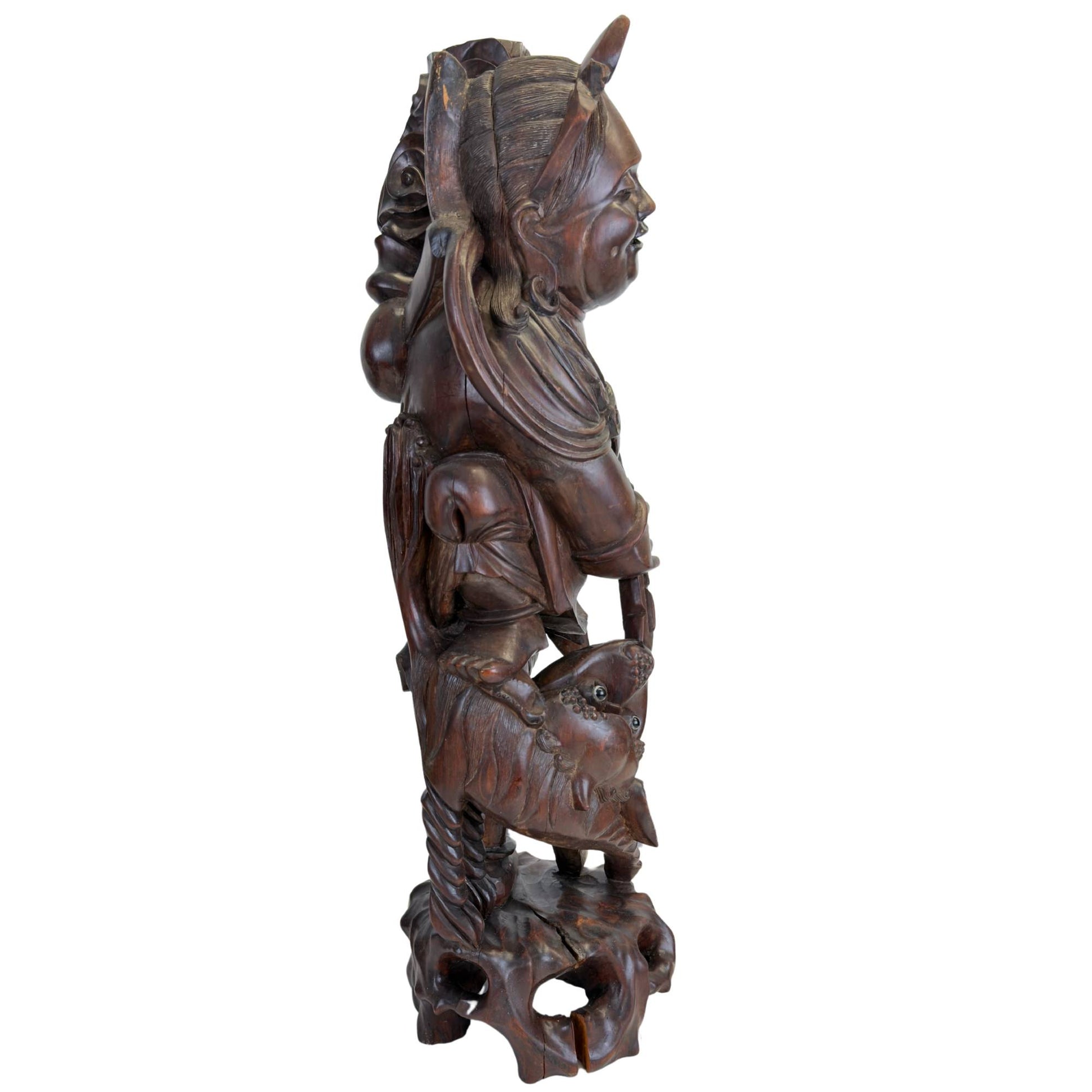 Detailed wooden statue of the Japanese god Ebisu with a fish