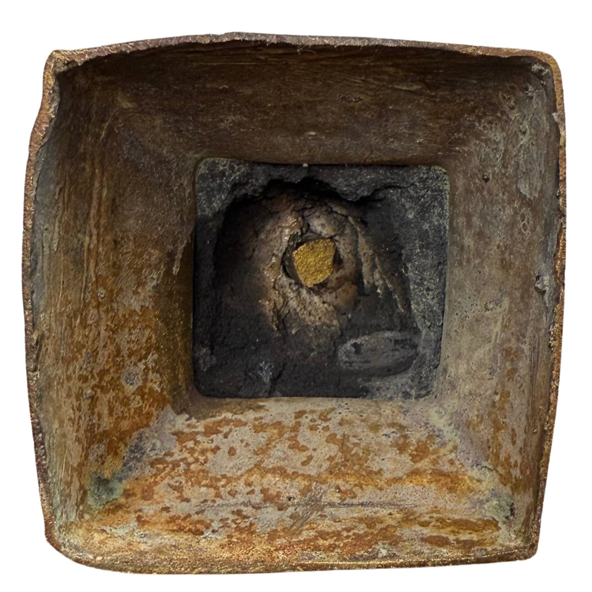 Forensic evidence of the underside with petrified casting core and the golden ritual deposit.