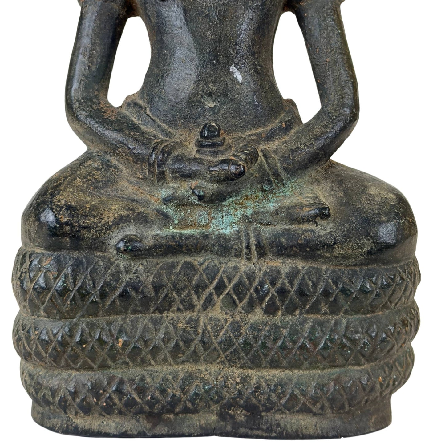Deep copper oxidation in the grooves of the engraved naga scales.
