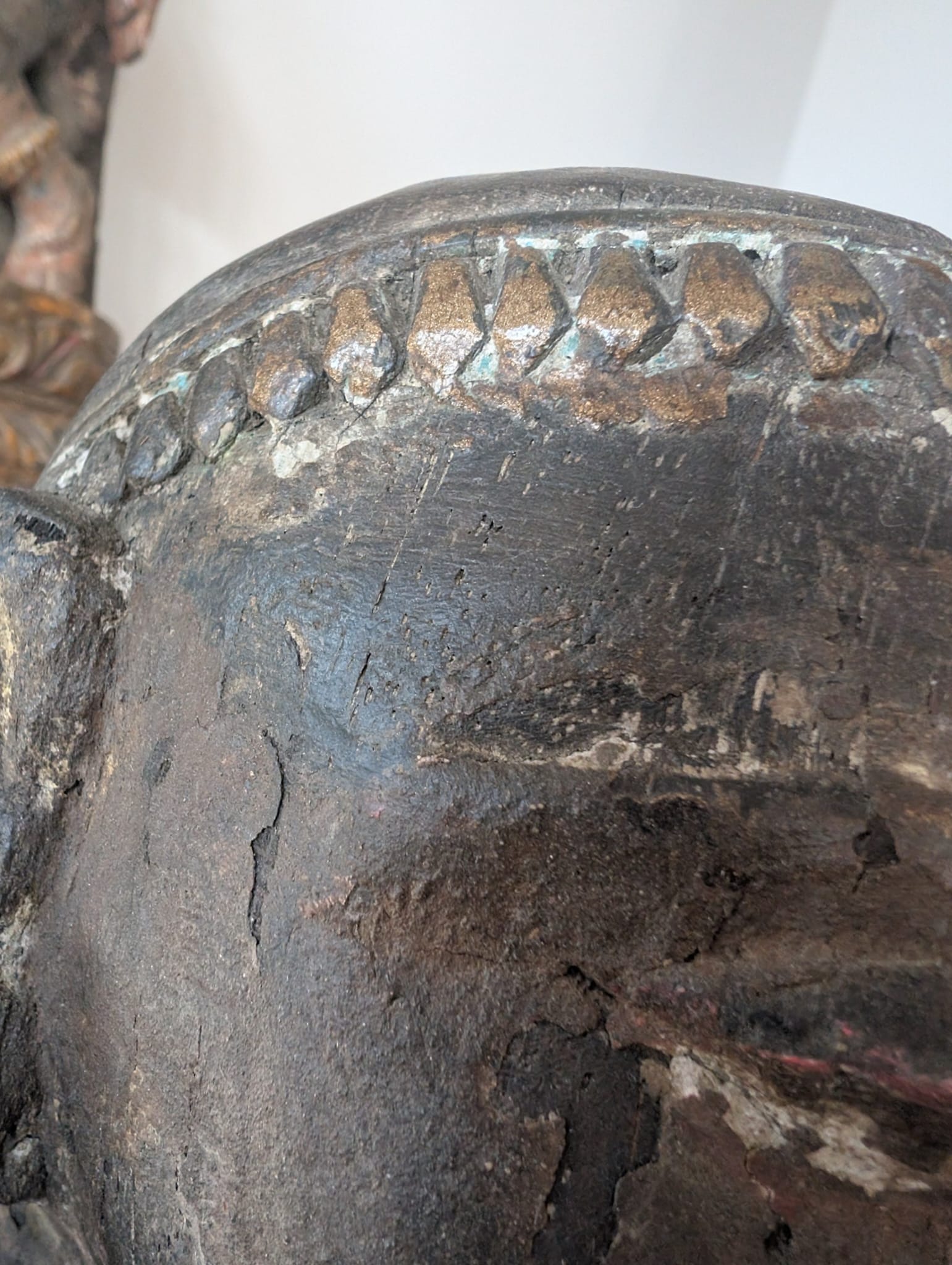 Detail of a wooden Lakshmi statue from Nepal with authentic patina and old structure
