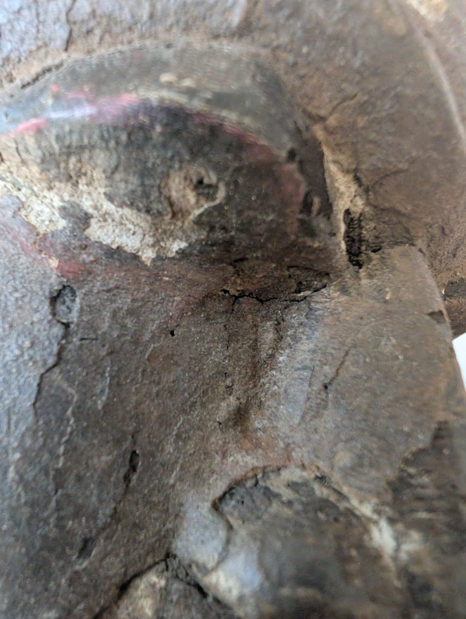 Detail of wooden Lakshmi statue from Nepal with aging and patina on the surface