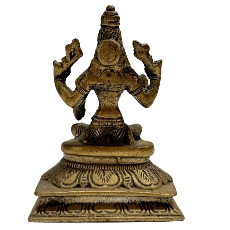 Bronze Lakshmi statue in lotus sitting position on an ornate throne
