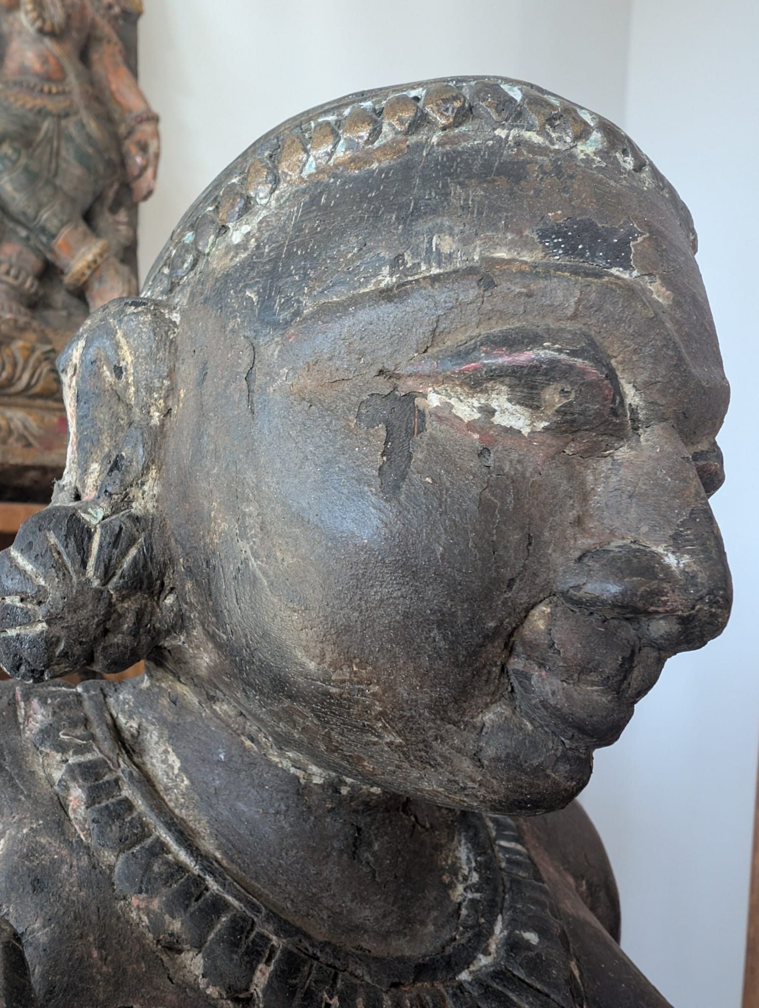 Detail of a wooden Lakshmi sculpture from Nepal in Newar style with traces of ritual use