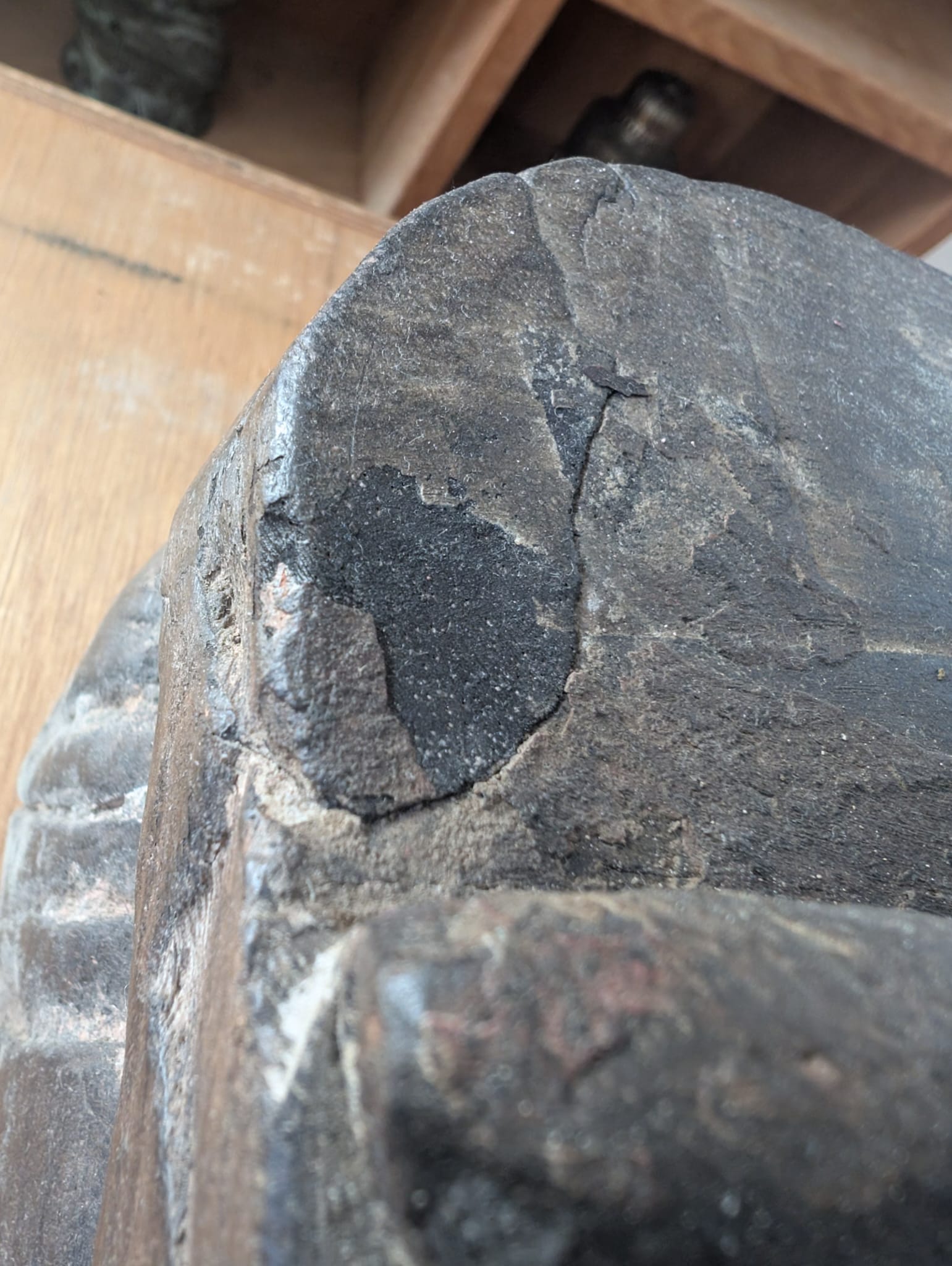 Detail of a solid wood Lakshmi statue from Nepal with visible chisel marks and texture