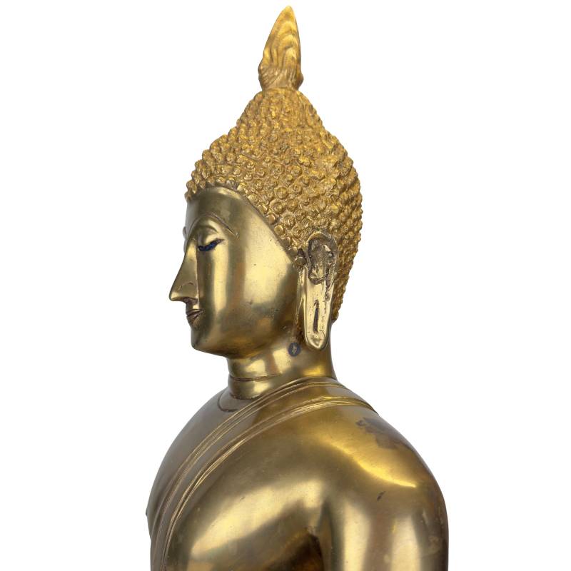 The characteristic long earlobes as a symbol of wisdom and royal lineage.