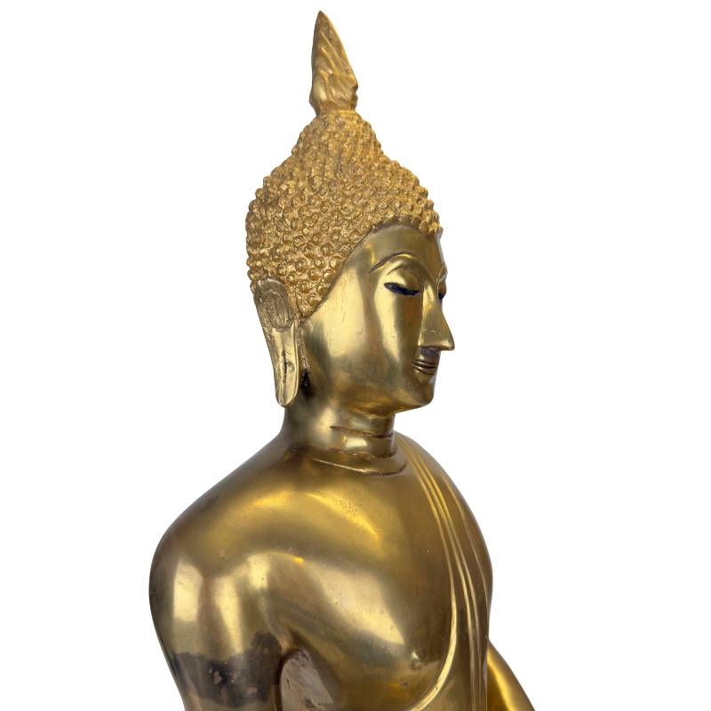 The characteristic long earlobes as a symbol of wisdom and royal lineage.