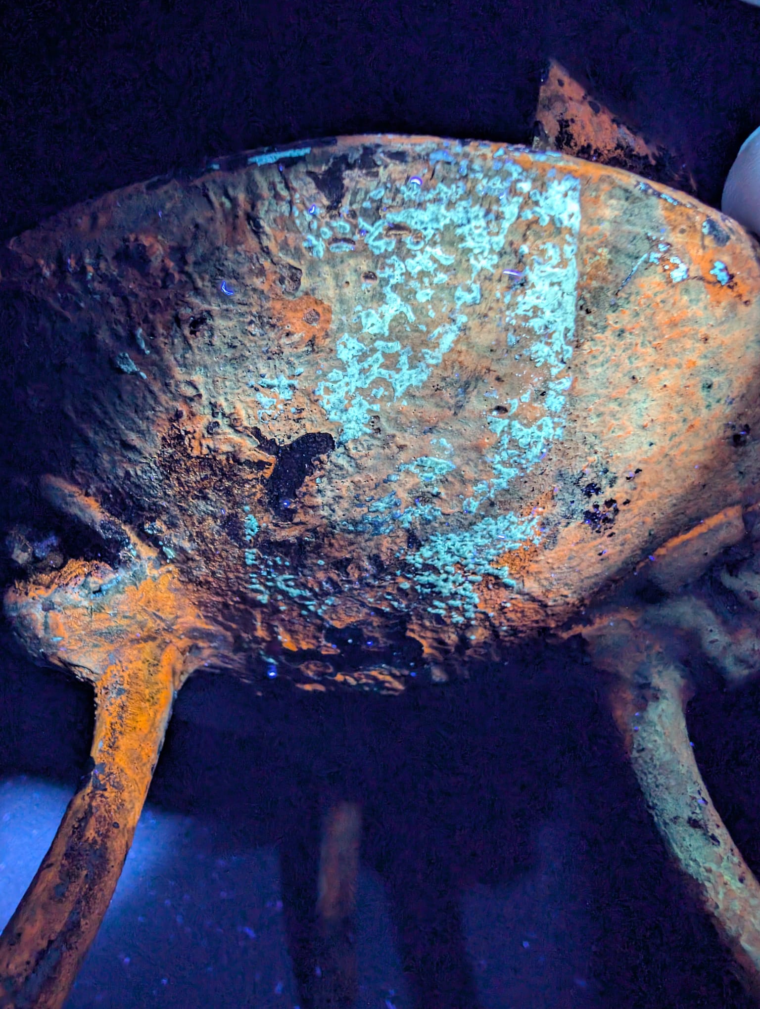 Detail of the surface showing the cold, smooth texture of old cast iron.