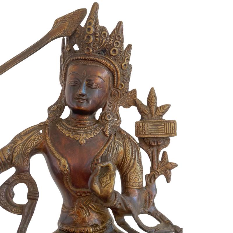 Manjushri statue with book of wisdom and sword