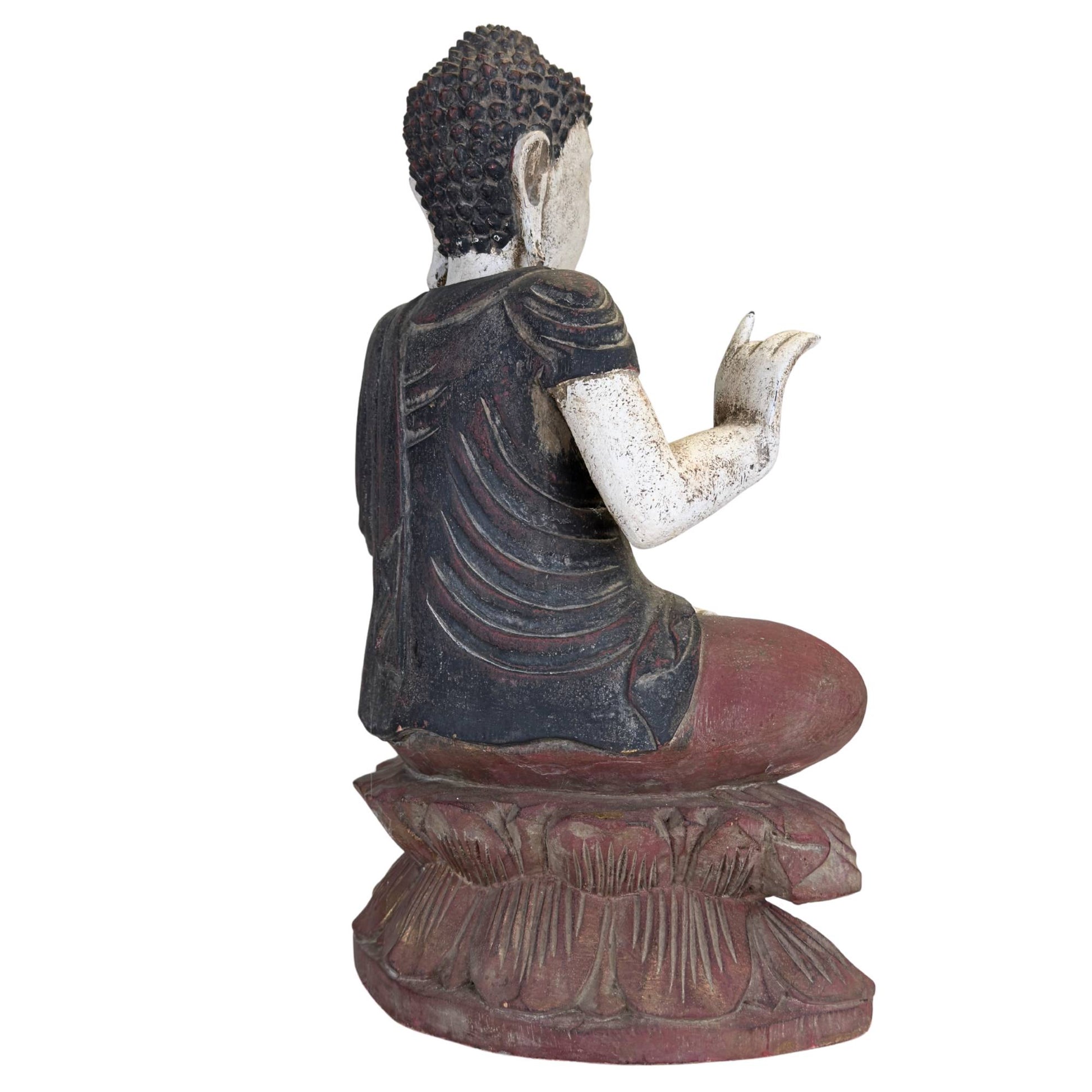 Wooden Medicine Buddha statue with old patina paint wear and a weathered spiritual appearance.