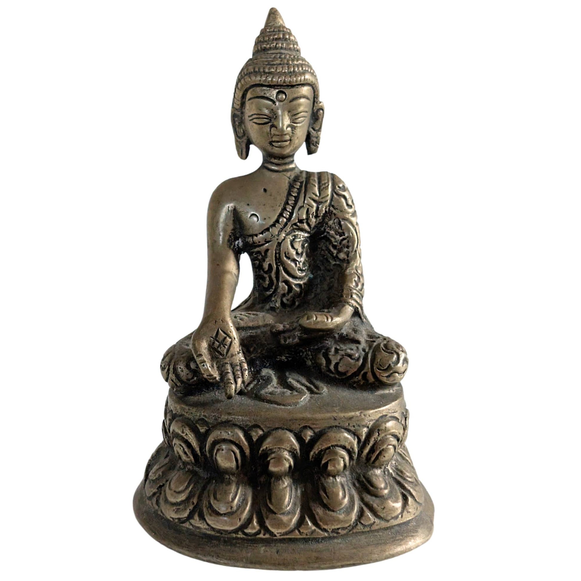 Front view of a handmade brass Buddha figurine from Nepal.