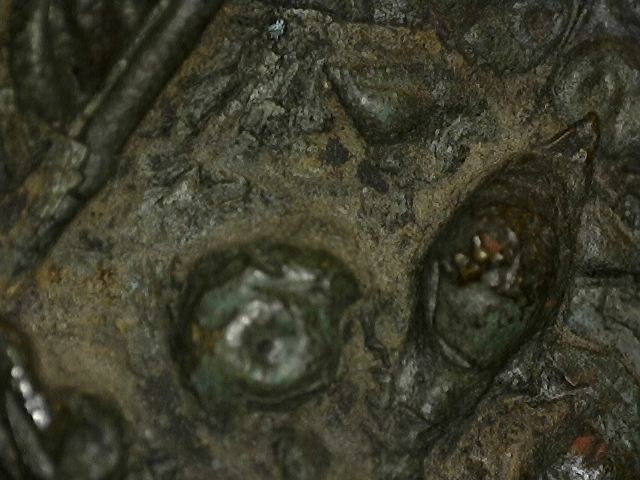 Microscope detail of natural aging on a Thai bronze figure