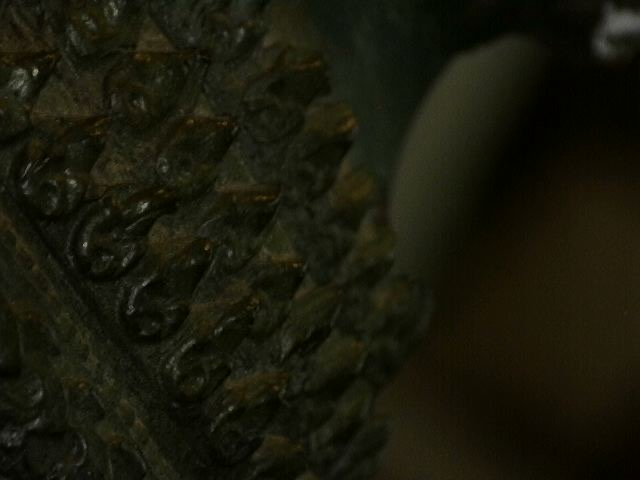 Microscope detail of wear on antique Thai bronze statue