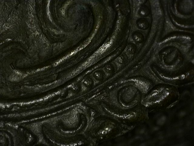 Microscope photo of patina layers on old Thai bronze artwork