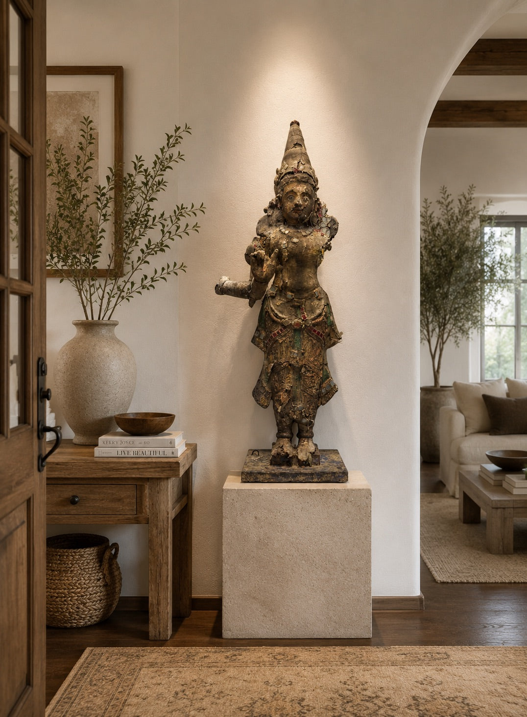 Monumental wooden Krishna statue with old polychromy, glass decoration, and a weathered temple appearance