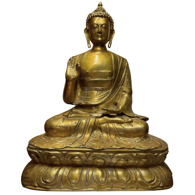 Monumental gilded Tibetan Shakyamuni Buddha statue as a symbol of protection, peace, and spiritual safety