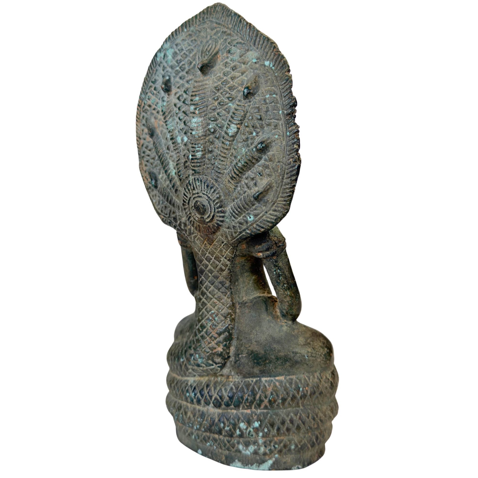 Seven-headed Naga King Mucalinda as protector of the meditating Buddha.