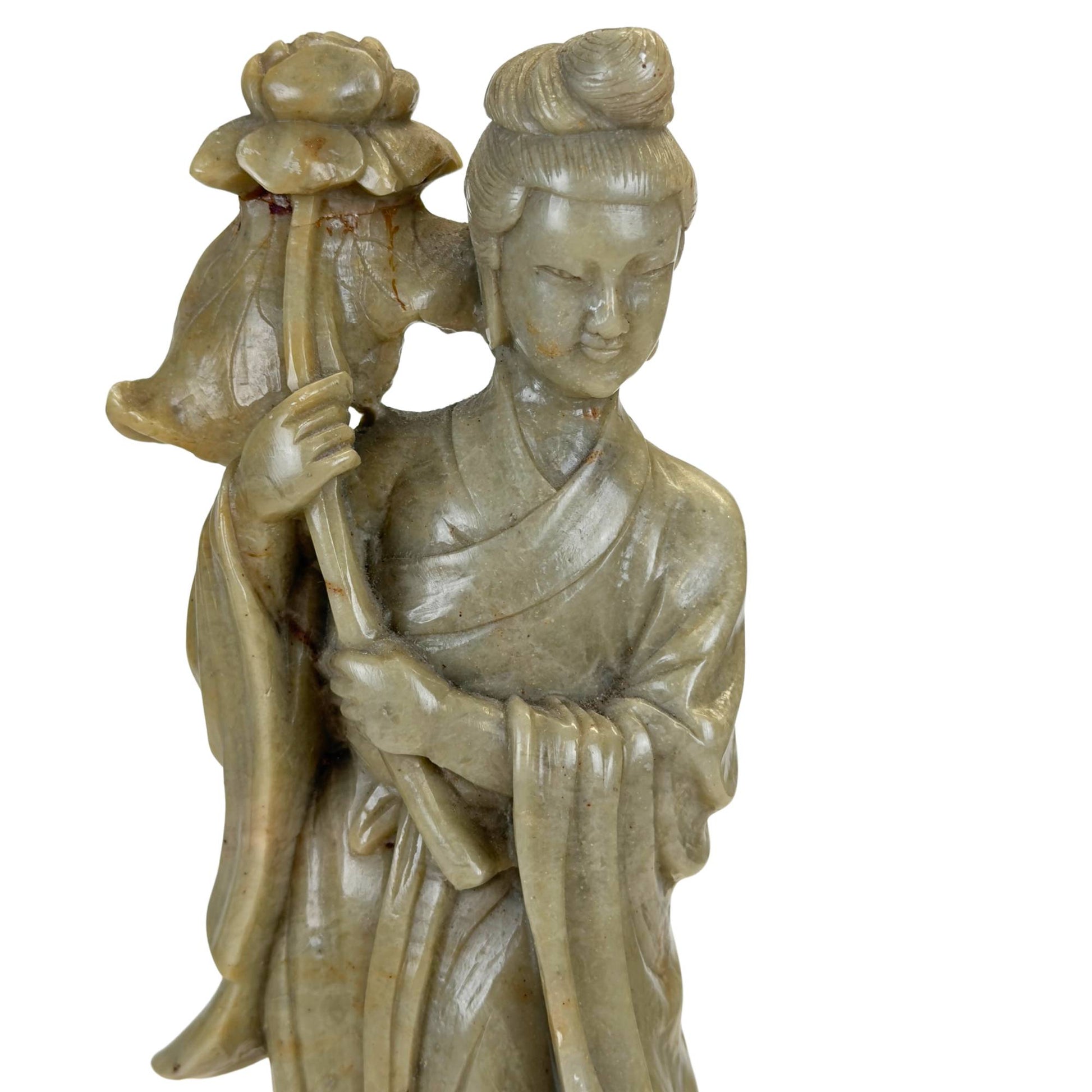 Natural green soapstone with visible mineral veins and artisanal carving.