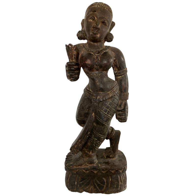 Wooden statue of Lakshmi from Nepal in Newar style, solid carved with remnants of polychromy and in a standing pose.