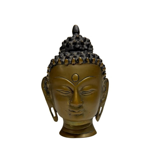 Fire-gilded Buddha head from Nepal as an authentic collector's item within Buddhist art